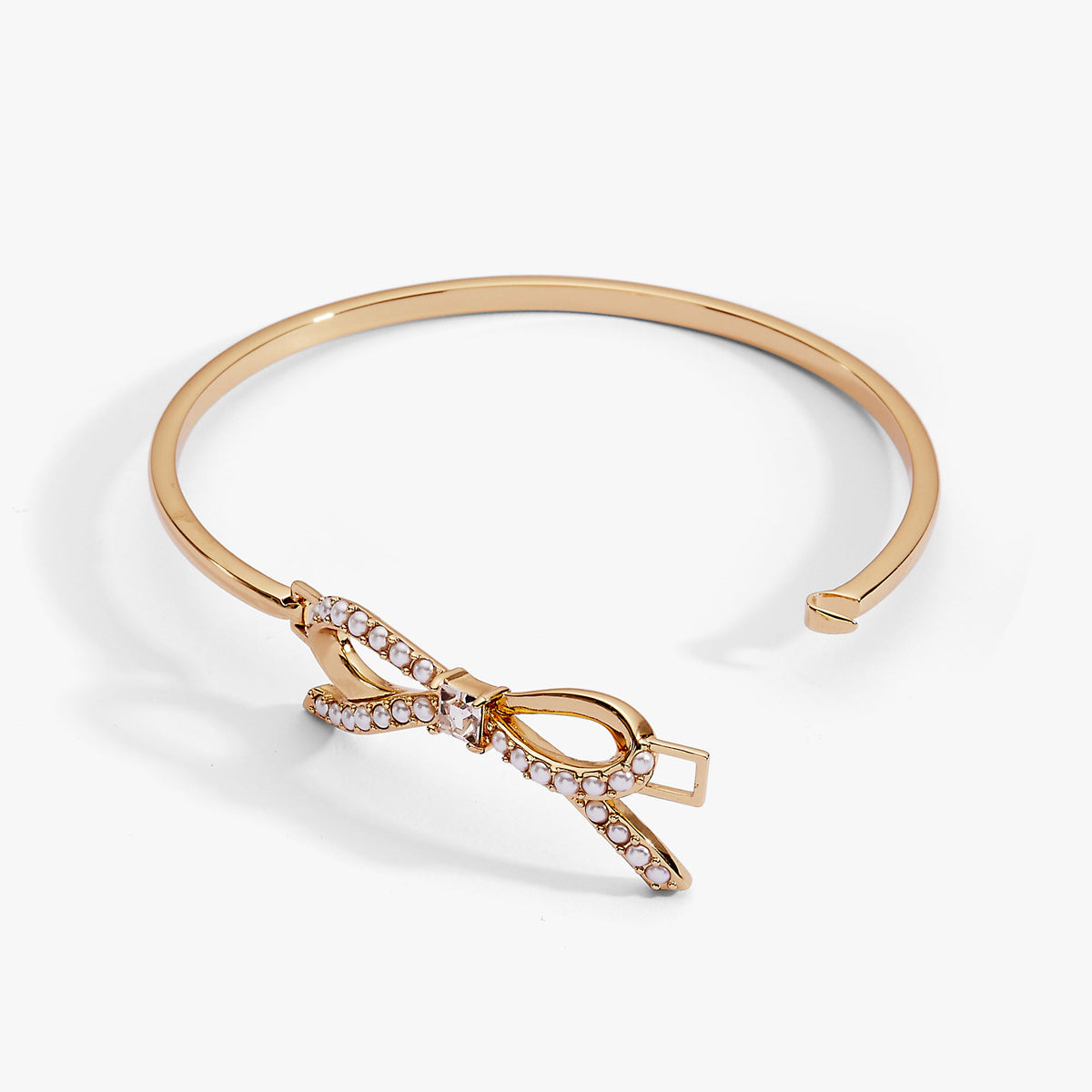 a gold bracelet with a bow