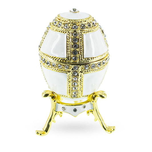 a white and gold egg shaped object with diamonds
