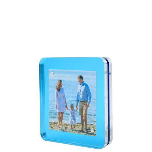 a picture frame with a picture of a family on the beach