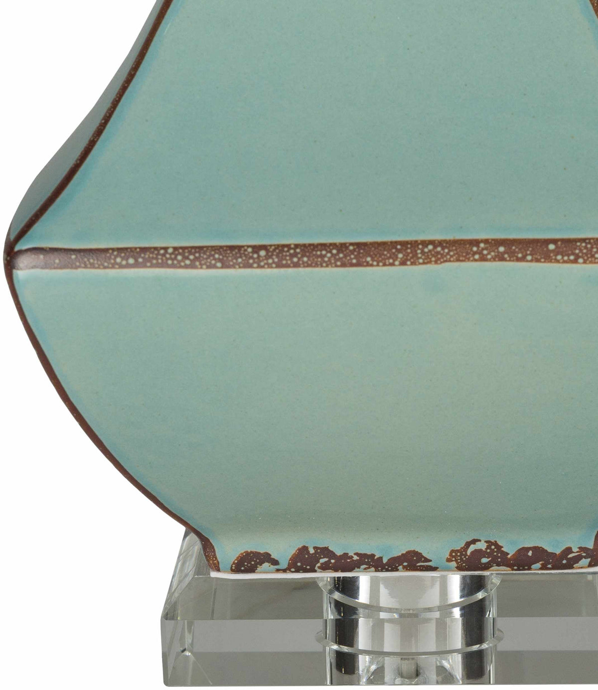 a close up of a blue and brown ceramic object
