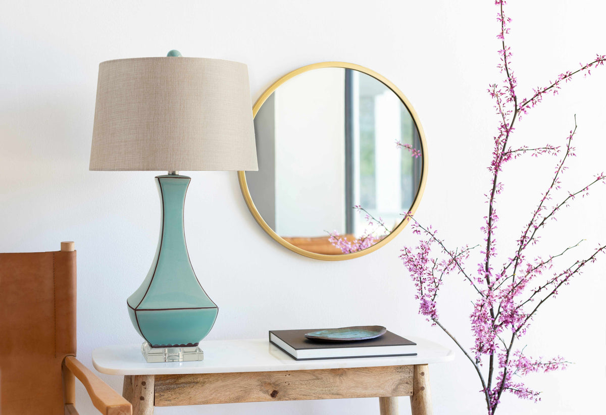 a table with a lamp and a plate on it