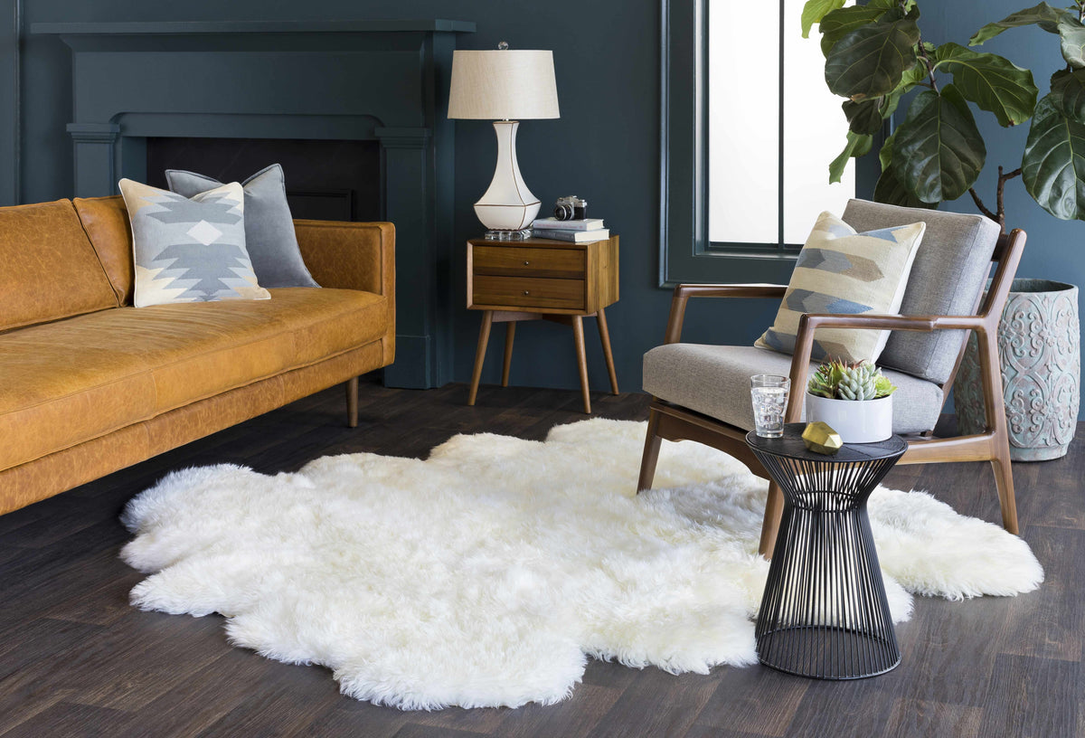 a room with a couch and a white rug