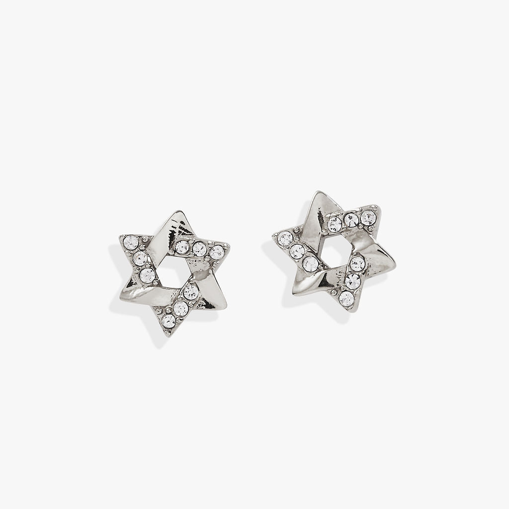 a pair of silver earrings with diamonds