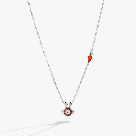 a necklace with a carrot and a stone pendant