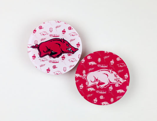 a pair of round red and white plates with a pig design