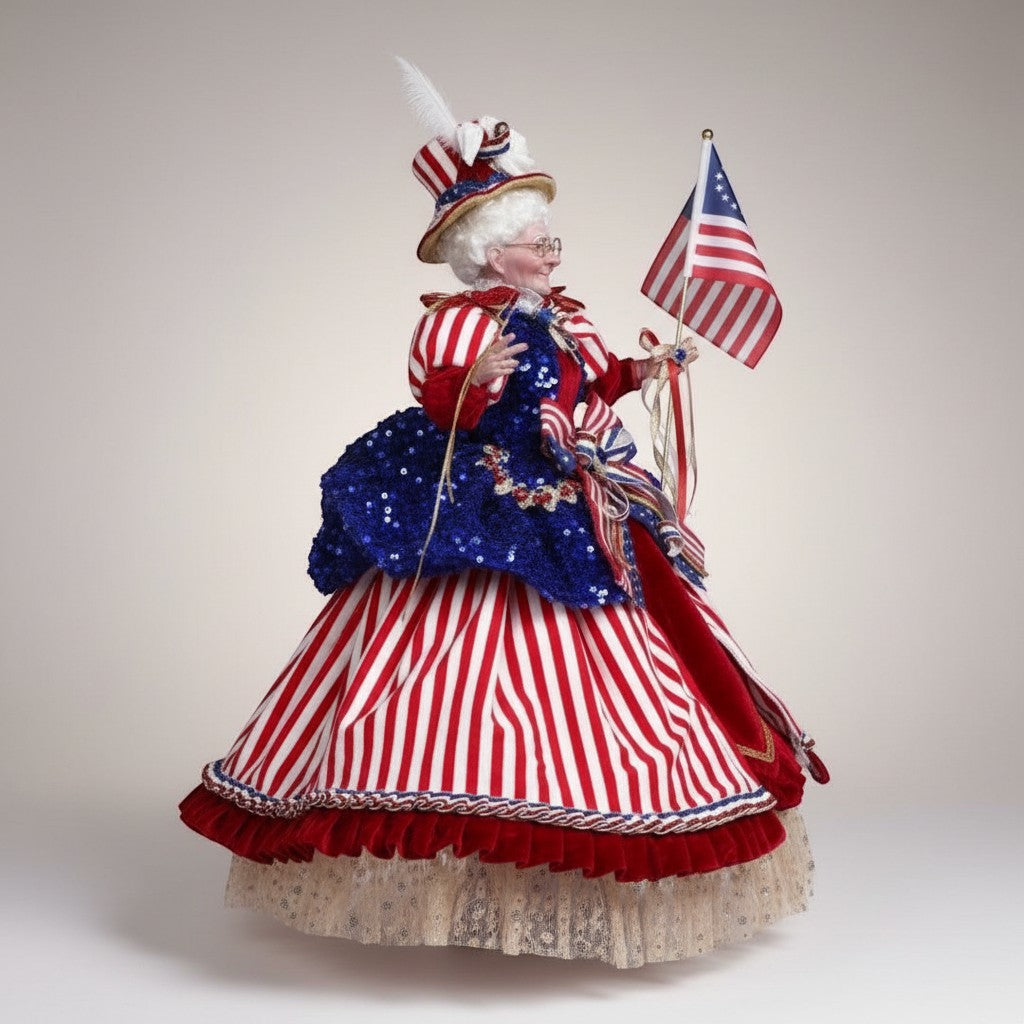 The Merry Hare Betsy Ross 23.5" collectible figurine in red & white striped dress, blue sequin bodice, holding American flag.