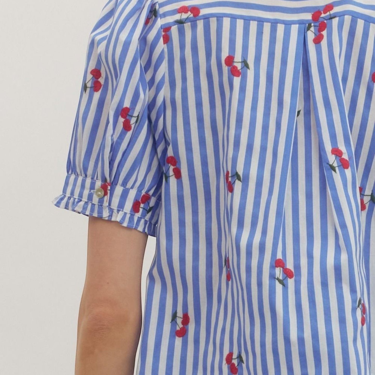 The Merry Hare blue and white striped cotton top with embroidered cherries and puff sleeves.