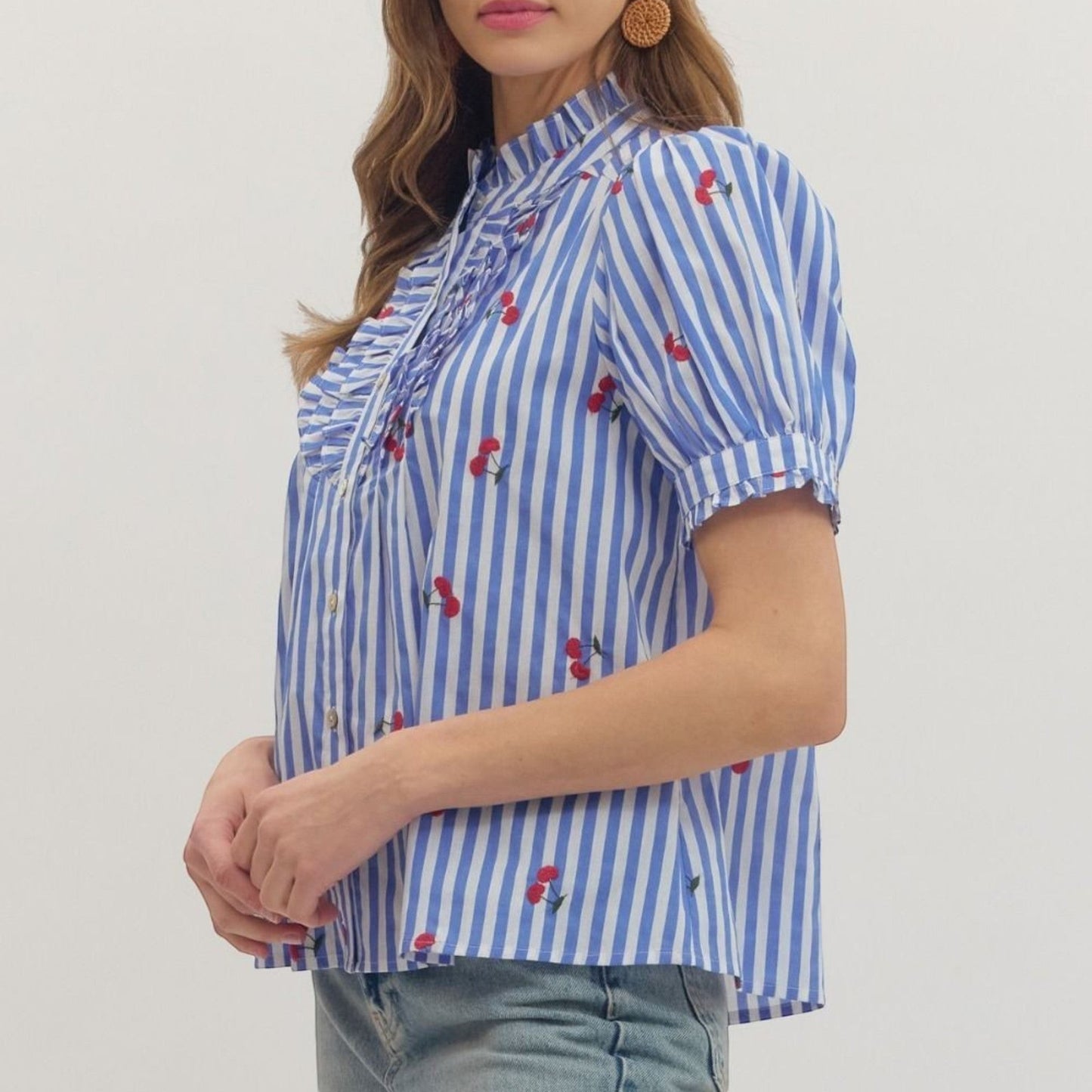 The Merry Hare blue and white striped cotton top with embroidered cherries, ruffle bib front, and puff short sleeves.
