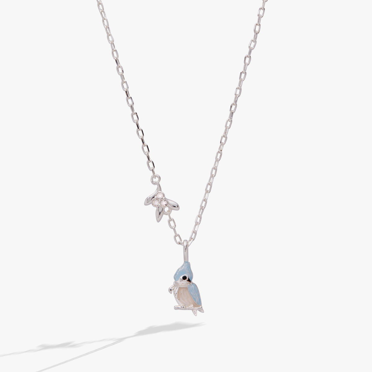 a necklace with a bird pendant