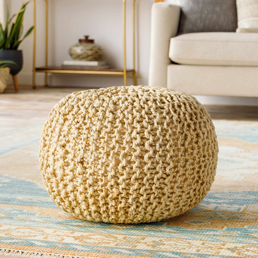 a round knitted cushion on a rug