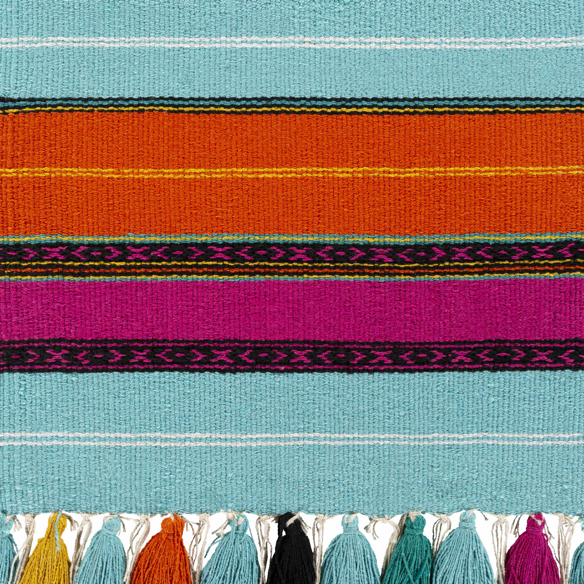 a colorful rug with tassels
