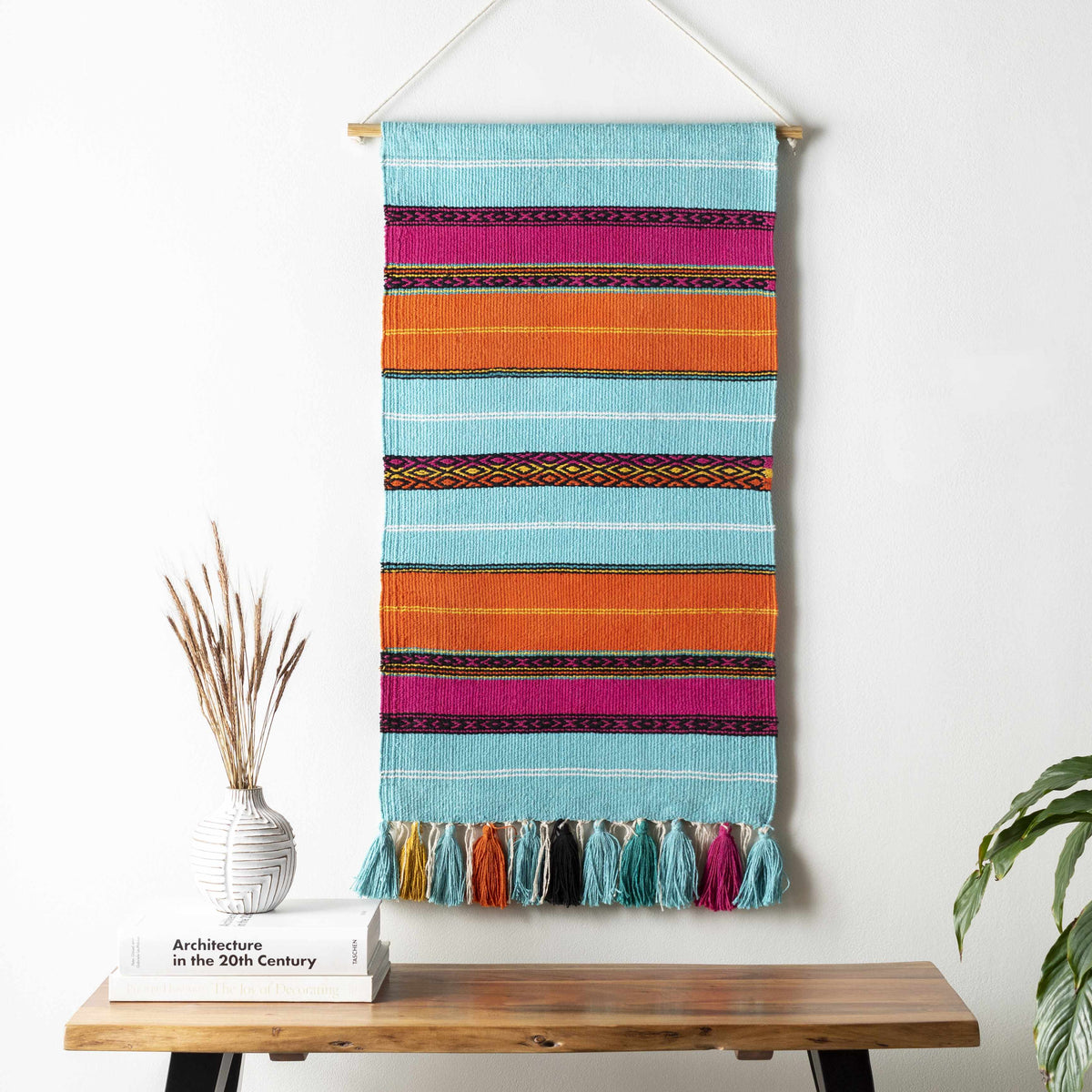 a colorful striped towel on a wall